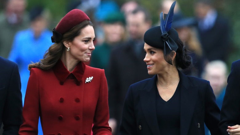 Kate Middleton Meghan Markle smiling at each other