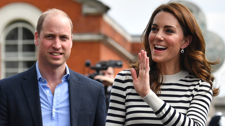 Prince William and Kate Middleton greet a crowd. 