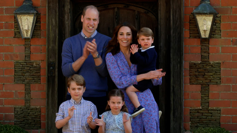 Prince William, Kate Middleton, and their children clapping 