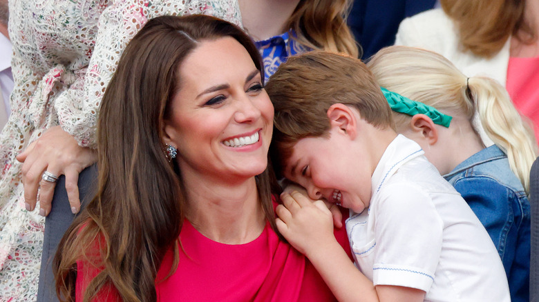 Kate and Prince Louis cuddle in the stands for an event