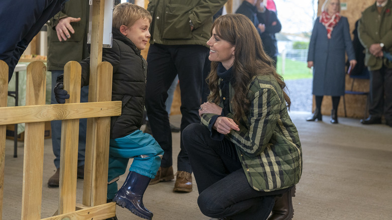 Kate Middleton talking to a young child at an event