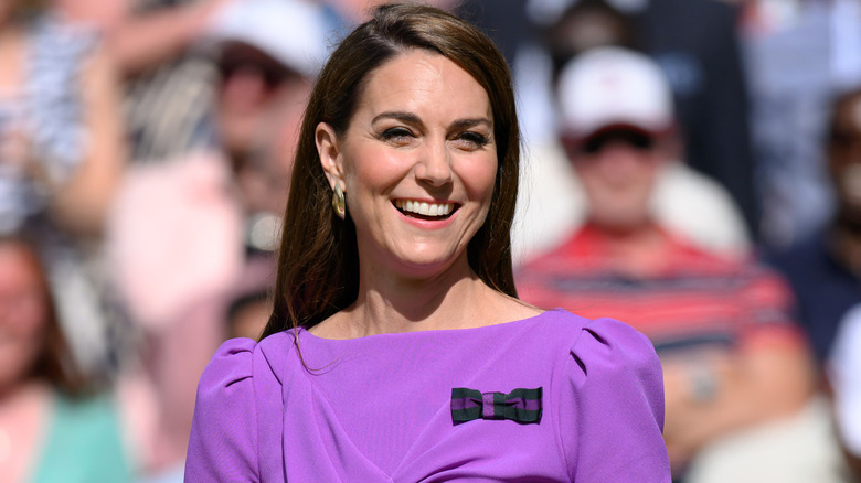 Kate Middleton smiling in purple dress at Wimbeldon