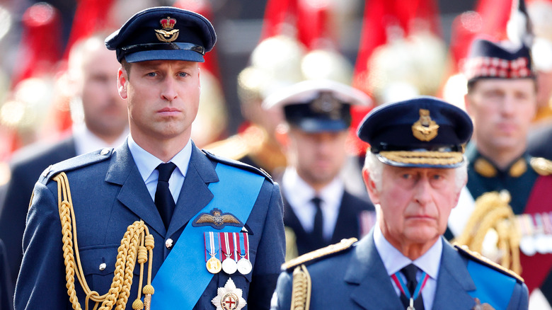 Prince William and King Charles looking serious