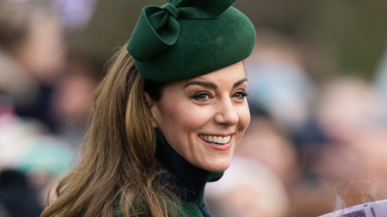 Kate Middleton wearing a green hat and smiling at the 2024 the Christmas Morning Service at Sandringham Church