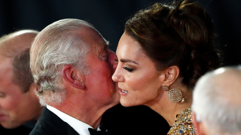 King Charles III kissing Kate Middleton on the cheek