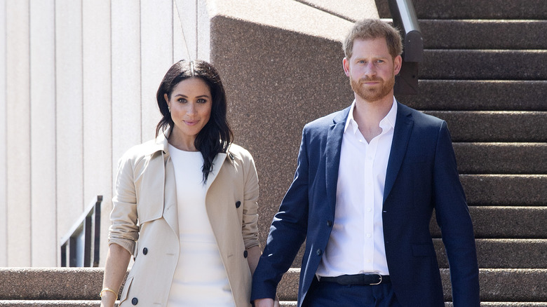 Meghan Markle and Prince Harry walking down steps