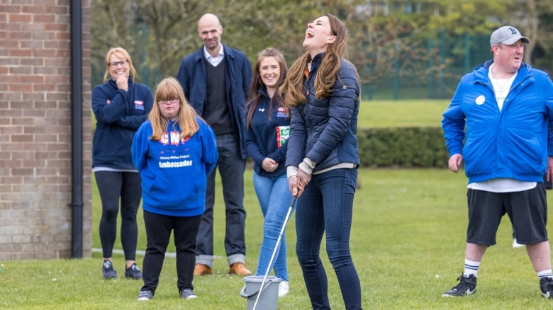 Kate Middleton laughs while golfing