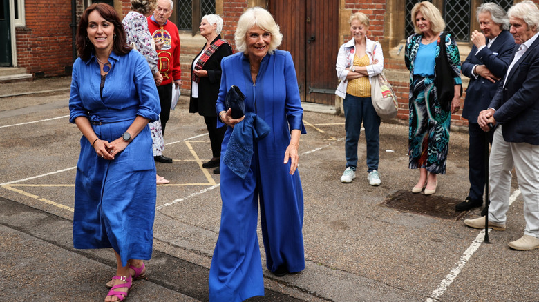 Queen Camilla sporting her cobalt blue jumpsuit at the Queen's Reading Room Literary Festival in June 2023