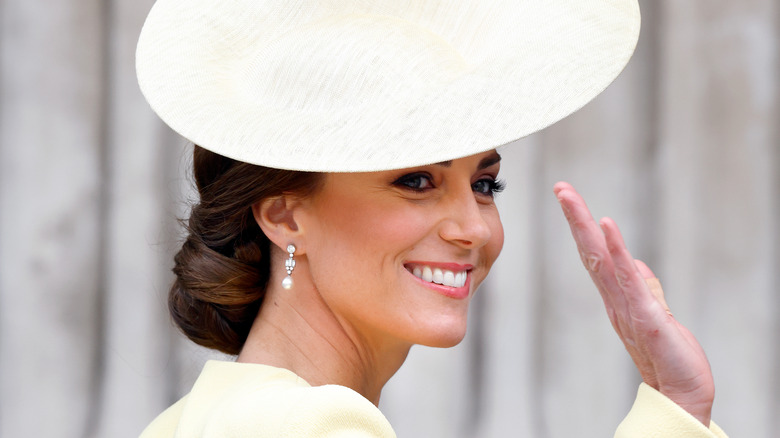 Kate Middleton smiling wearing pearl earrings