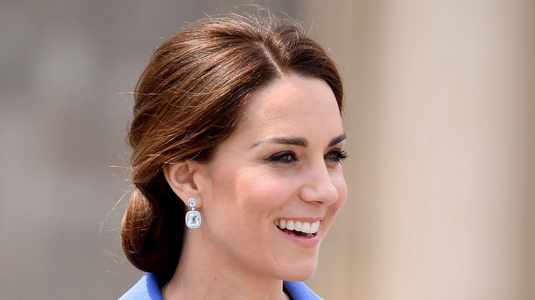 Kate Middleton smiling in a periwinkle suit