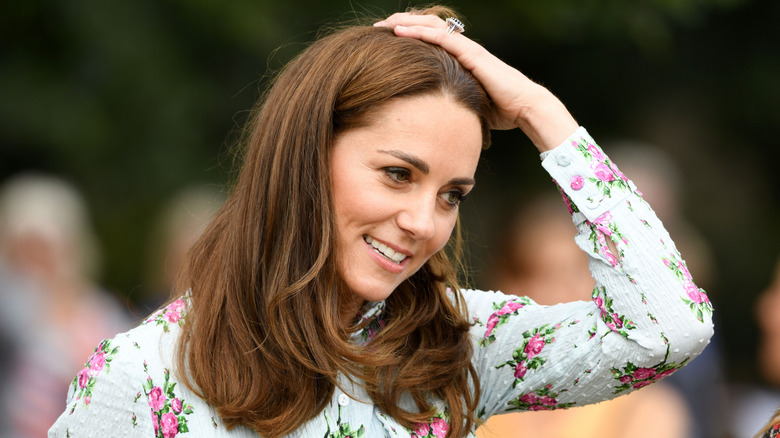 Kate Middleton touching her hair