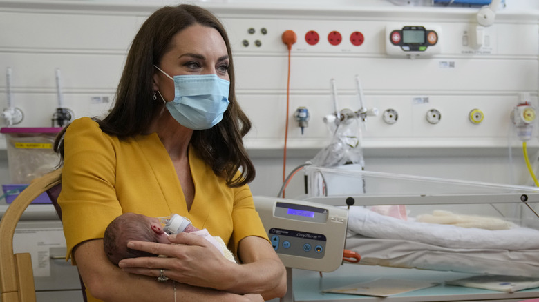 Kate Middleton cradling a newborn