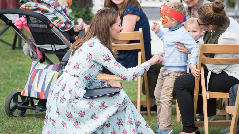 Kate Middleton talking to a child