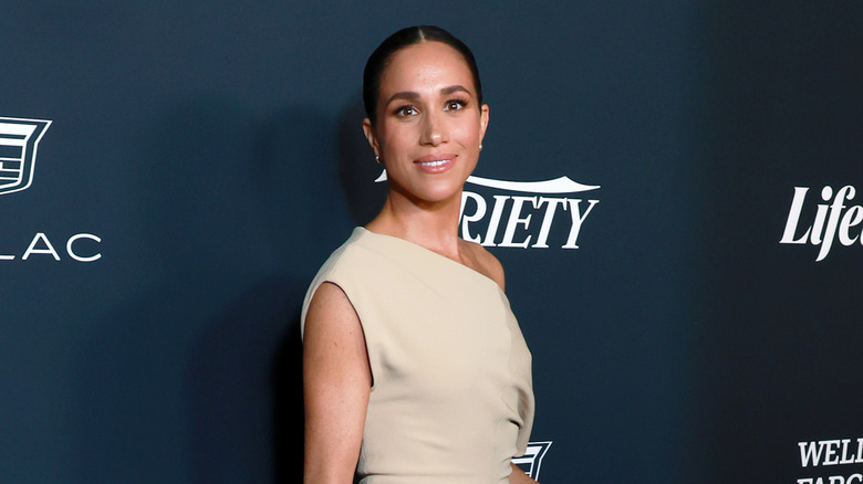 Meghan Markle one-shoulder dress hair pulled back