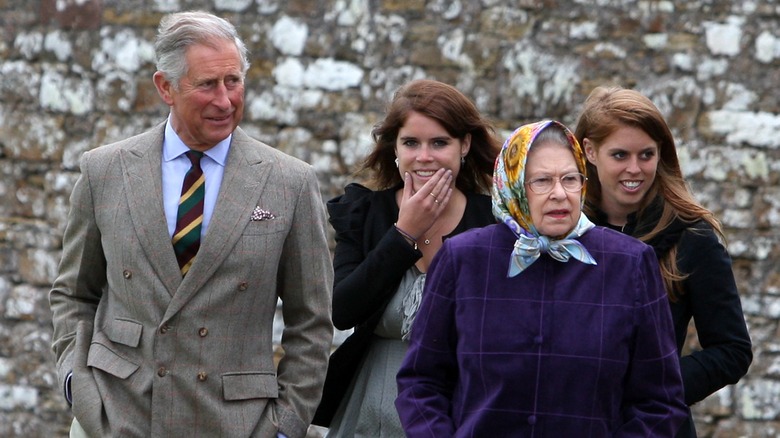 Then-Prince Charles, Princess Eugenie, Queen Elizabeth II, Princess Beatrice walking