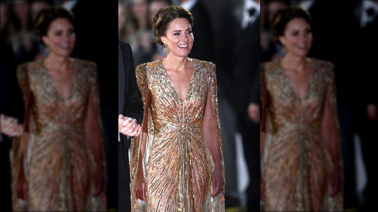 Kate Middleton smiling in gold dress