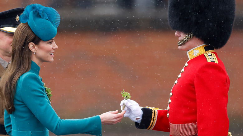 Kate Middleton hands shamrock to British guard