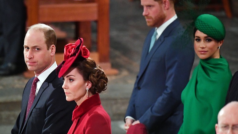 Prince William, Kate Middleton standing in front of Prince Harry, Meghan Markle