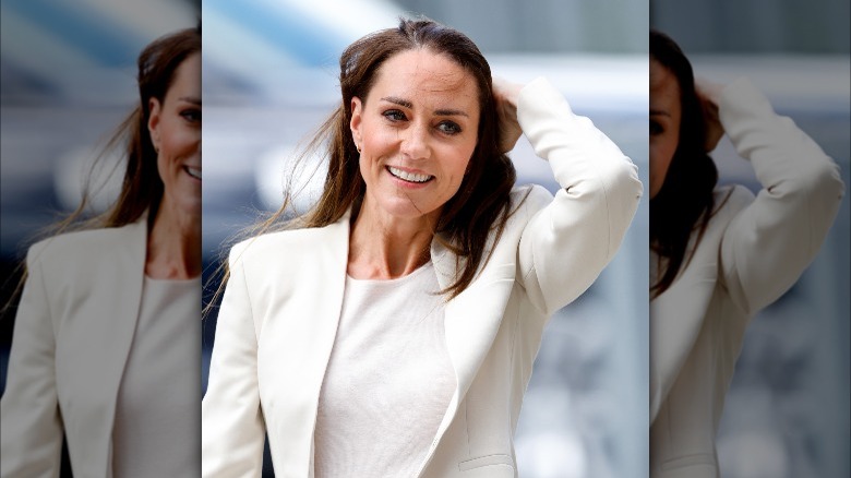 Kate Middleton brushing hair out of her face