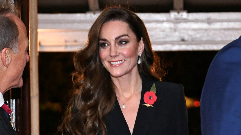 Kate Middleton smiling with long locks draped over shoulder