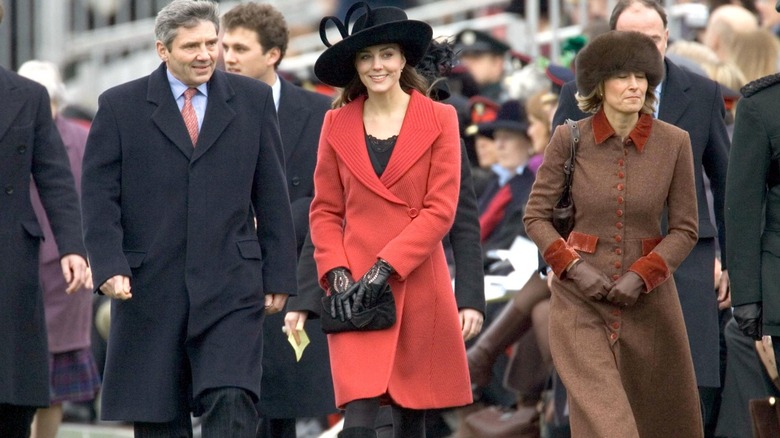 Michael Middleton, Kate Middleton, and Carole Middleton walking in a line