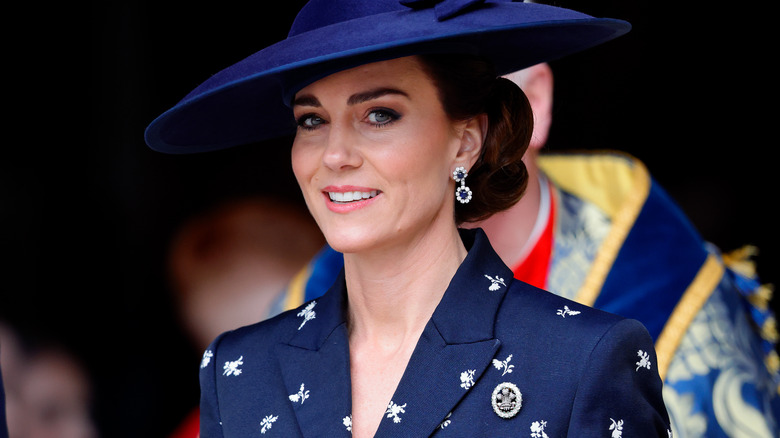 Princess Catherine smiling wearing a navy hat