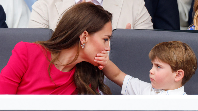 Prince Louis puts his hand over Kate Middleton's mouth