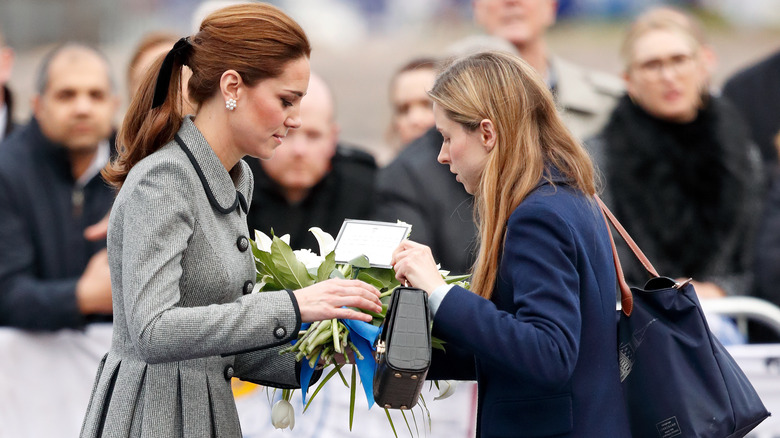 Princess Catherine handing flowers to Natalie Barrows