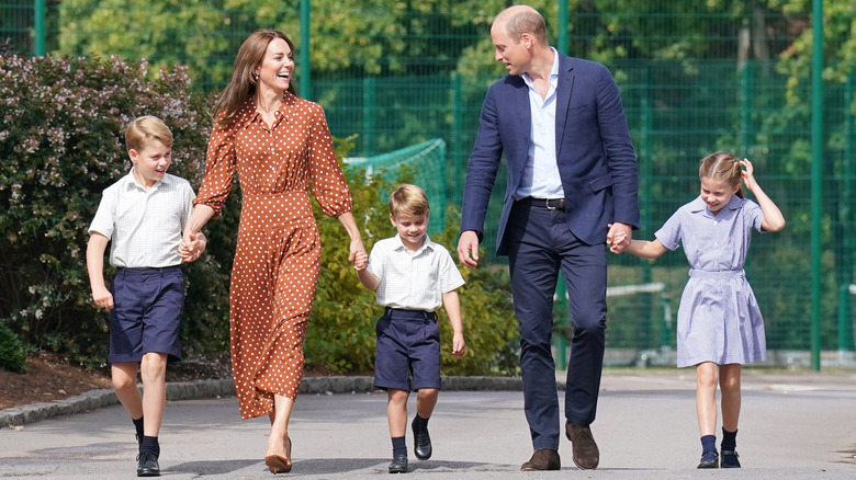 The Prince and Princess of Wales walking with their children