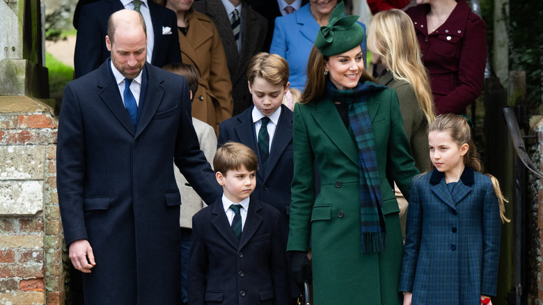 Prince William and Kate Middleton walk with their three children