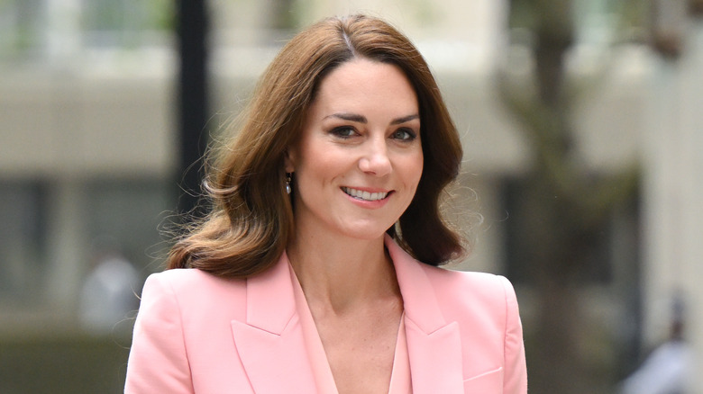 Kate Middleton smiling in pink suit