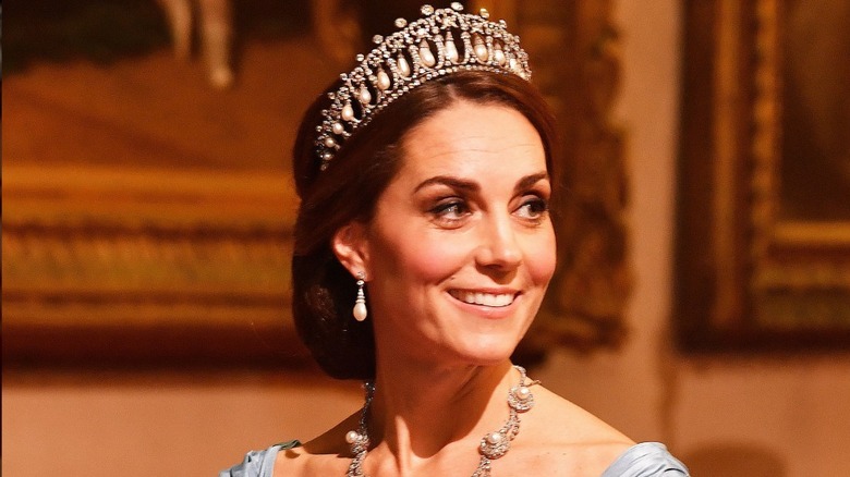 Kate Middleton smiling and wearing a tiara