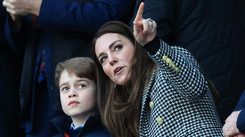 Prince George looking as Kate Middleton points at something