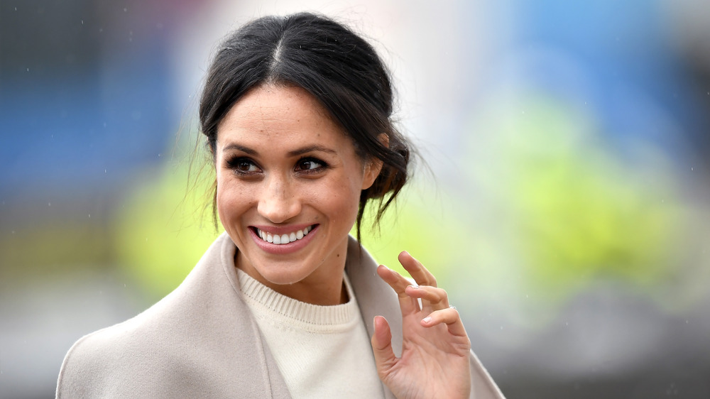 Meghan Markle waves