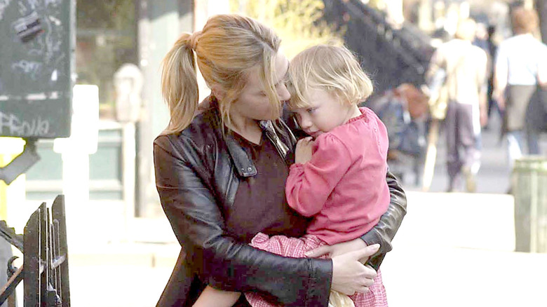 Kate Winslet holding young Mia Threapleton