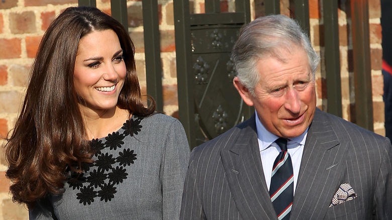 Kate Middleton and King Charles walking outside together
