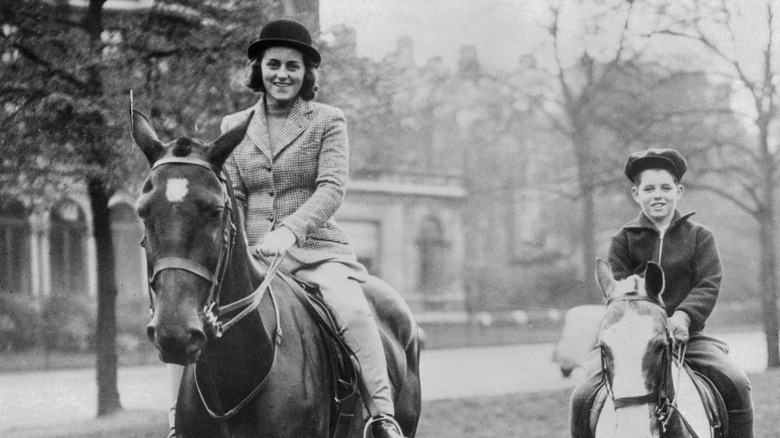 Kathleen Kennedy riding a horse with her brother