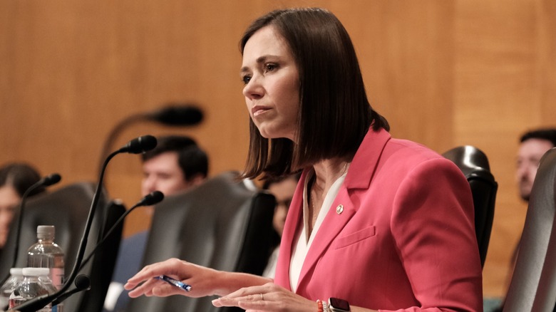 Katie Britt sitting at microphone