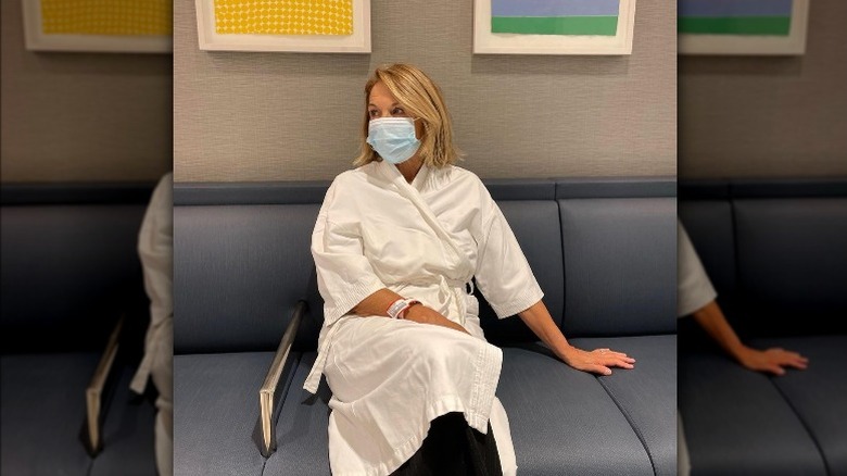 Katie Couric wearing mask and hospital gown