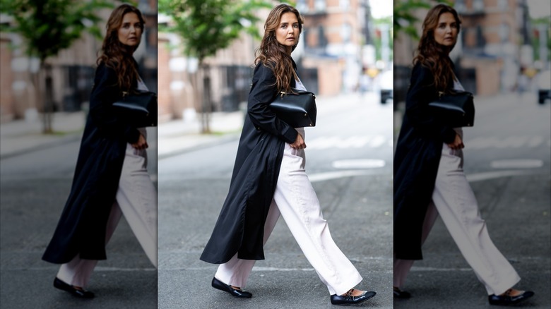 Katie Holmes looking into the camera crossing the street