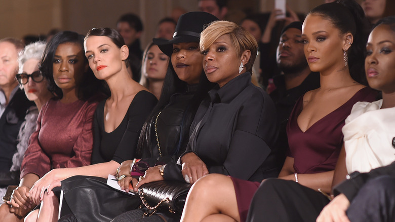 Katie Holmes sitting near Rihanna at a Zac Posen fashion show