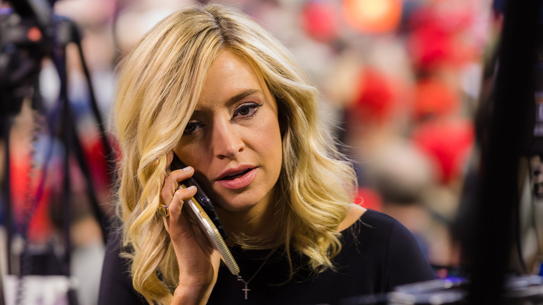 Kayleigh McEnany on a cellphone at a Trump rally.