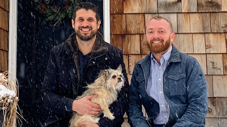 Evan Thomas and Keith Bynum with their dog in the snow