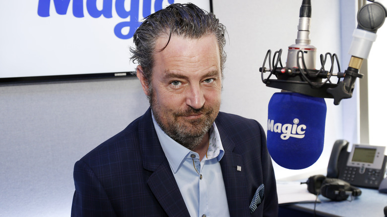 Matthew Perry posing at Magic Radio Studio in 2015