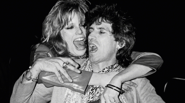 Patti Hansen jumps on Keith Richards' back