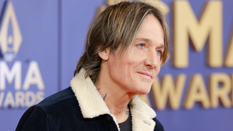 Head and shoulders of Keith Urban, looking off with a slight smile.