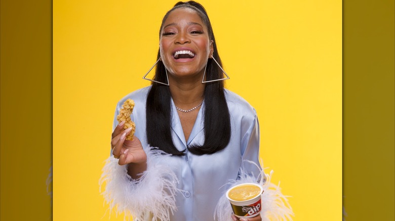 Keke Palmer holding chicken and Doritos Dip