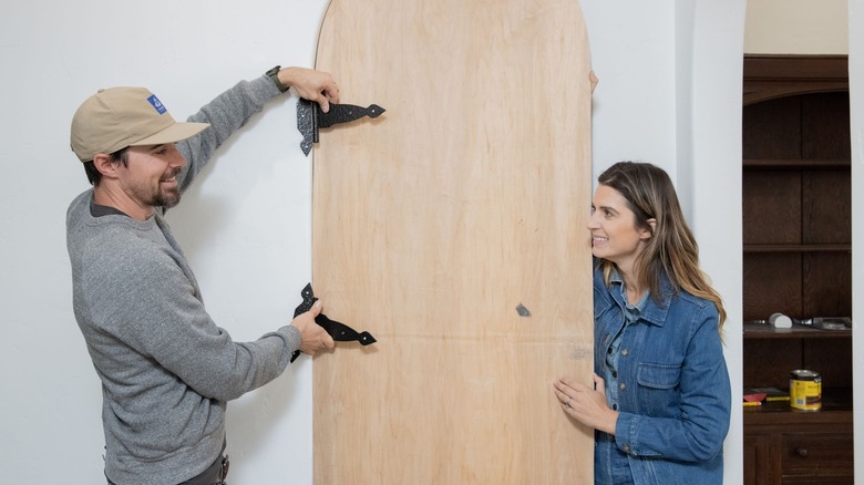 Kele Dobrinki and Christina Valencia working on custom door