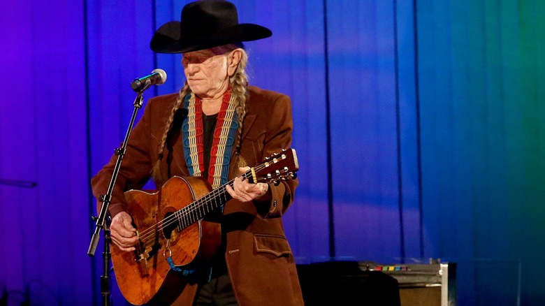 Willie Nelson playing guitar