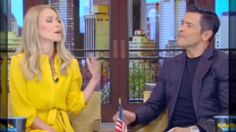 Kelly Ripa and Mark Consuelos chatting on the set of Live with Kelly and Mark